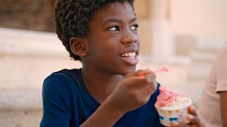A joyful child enjoying ice cream during a Mediterranean excursion in Cagliari, Italy | MSC Cruises