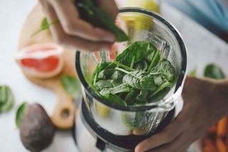 Fresh ingredients including spinach and grapefruit being prepared in a mixer for a nutritious beverage | MSC Cruises