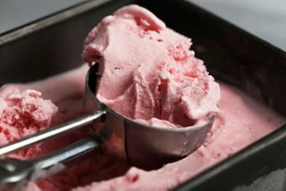 A scoop of creamy pink gelato ready to be served from the container | MSC Cruises