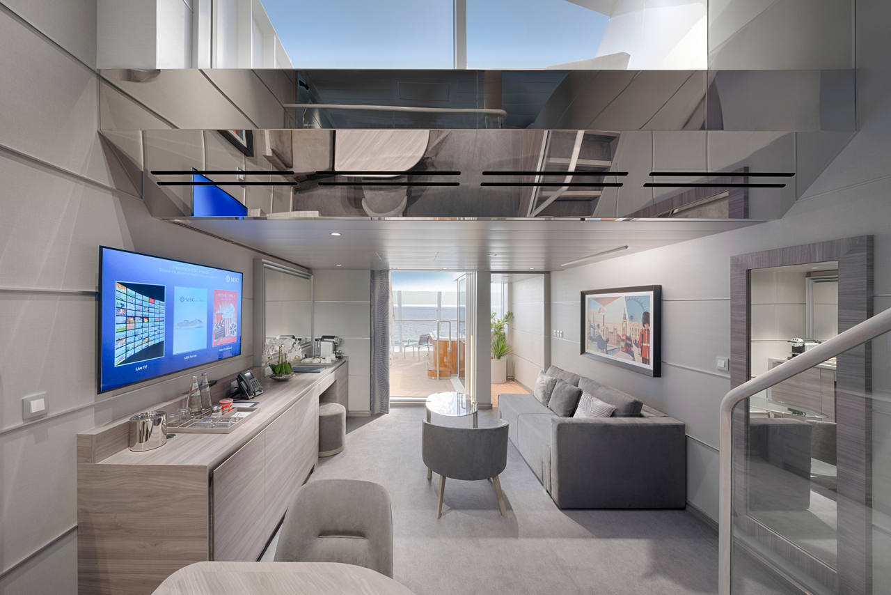 A luxurious MSC Yacht Club Duplex Suite featuring stylish furnishings and a view of the sea | MSC Cruises