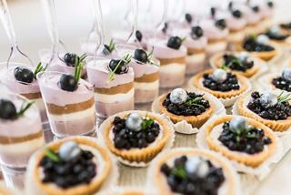 Delicious pastry tarts filled with fresh berries arranged elegantly at a buffet | MSC Cruises