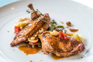 A beautifully plated grilled chicken dish accompanied by vibrant vegetables, showcasing culinary excellence | MSC Cruises