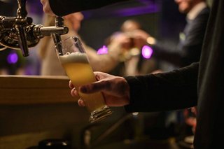 A bartender serves a refreshing beer at The Purple Bar aboard MSC Orchestra | MSC Cruises