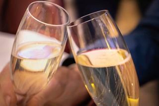 Two champagne flutes clinking together in celebration, symbolising joy and togetherness | MSC Cruises