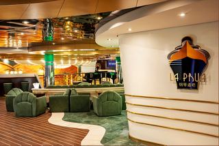 Relax in the inviting La Prua Piano Bar, featuring comfortable seating and vibrant decor for an enjoyable experience | MSC Cruises