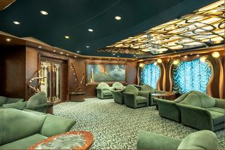 Elegant seating area in The Cigar Lounge with large windows offering scenic views | MSC Cruises