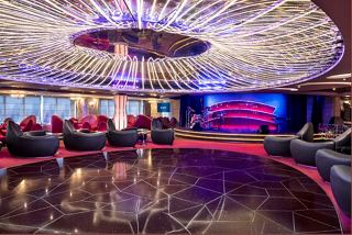 Elegant lounge area with plush seating and vibrant decor, perfect for relaxation and entertainment aboard | MSC Cruises