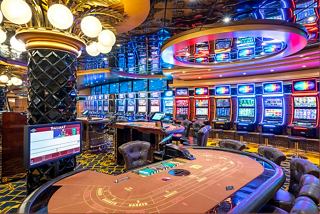 A lively casino area on the MSC Splendida, featuring vibrant decor and gaming tables for an exciting experience | MSC Cruises