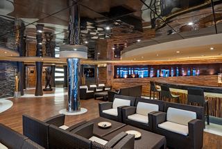 A welcoming lounge area with comfortable seating and a stylish bar, perfect for relaxation on board | MSC Cruises