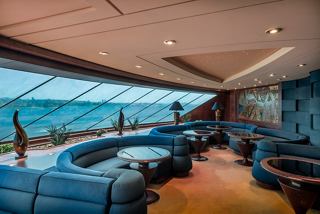A luxurious lounge area with ocean views features modern seating and a serene atmosphere for relaxation | MSC Cruises