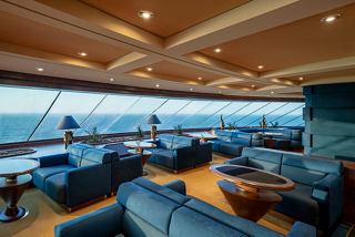 A stylish lounge area with comfortable seating and panoramic sea views aboard the MSC Splendida | MSC Cruises