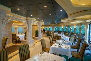 Elegant dining area in L'Olivo Restaurant with beautiful views, inviting decor, and comfortable seating | MSC Cruises