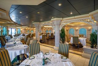 L'Olivo Restaurant features elegant dining tables and a warm sitting area with glass accents and plants | MSC Cruises