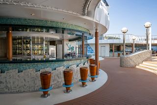 The inviting Tartaruga Bar features a spacious outdoor area with a stylish bar counter and comfortable seating | MSC Cruises