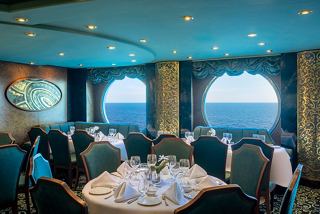 A beautifully arranged dining area with elegant tables and porthole views of the sea | MSC Cruises