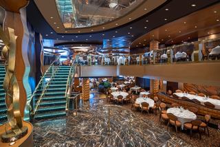 An inviting dining area with chairs and tables, offering a glimpse of La Reggia Restaurant's elegant atmosphere | MSC Cruises