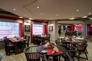 A warm dining area in the Butcher's Cut restaurant on MSC Splendida, featuring elegant seating and inviting decor | MSC Cruises