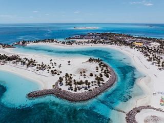 Aerial view of Ocean Cay MSC Marine Reserve featuring white sandy beaches and turquoise waters under a clear blue sky | MSC Cruises