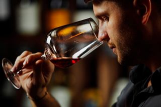 A man enjoys a close-up experience of tasting red wine on MSC Euribia | MSC Cruises