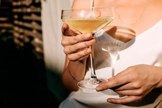 Woman holding a cocktail glass aboard MSC Grandiosa cruise ship | MSC Cruises