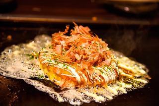 A delicious serving of Okonomiyaki with seafood, showcasing a mix of flavours and textures | MSC Cruises
