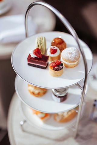 A tiered cake stand filled with assorted pastries, perfect for afternoon tea in the MSC Yacht Club | MSC Cruises