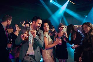 Guests enjoying a lively night at The Amber Bar with drinks and dancing on MSC Orchestra | MSC Cruises