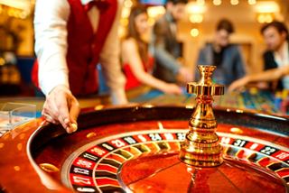 Guests enjoying a game of roulette at the Casino Royal on MSC Poesia with a croupier guiding the play | MSC Cruises