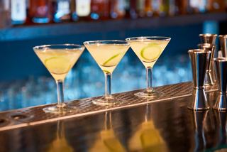 Three vibrant cocktails with lime garnish lined up on a bar counter at Byblos Discoteca, inviting moments of celebration | MSC Cruises