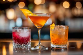 Three vibrant cocktails elegantly arranged on a bar counter, inviting relaxation and enjoyment | MSC Cruises