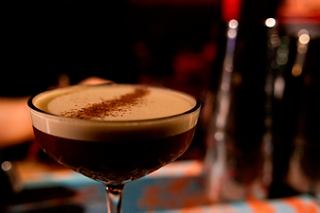 A close-up of a luxurious espresso martini cocktail served at Le Gocce Bar on MSC Magnifica | MSC Cruises