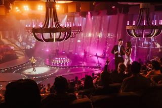 A vibrant live performance with singers and dancers captivating the audience onboard MSC World America | MSC Cruises