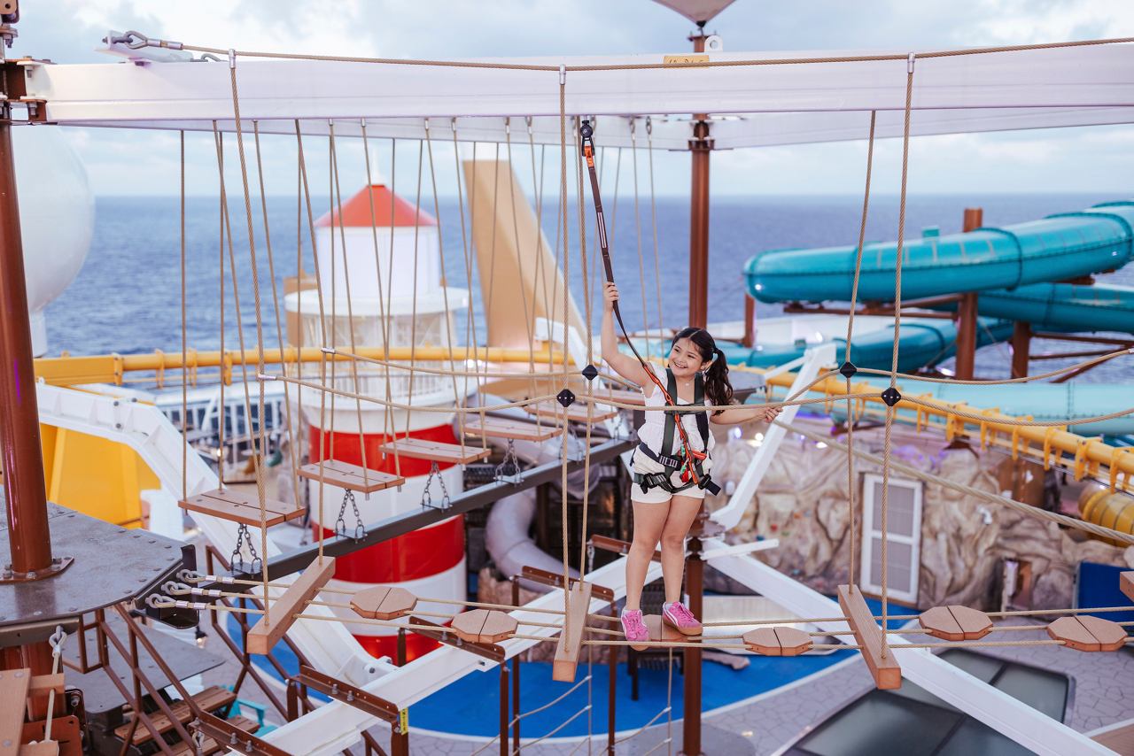 A joyful child enjoys the Himalayan Bridge, surrounded by vibrant colours and the sea under a clear sky | MSC Cruises