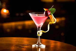 A vibrant cocktail garnished with mango and cherry, served in the Carousel Lounge aboard MSC Meraviglia | MSC Cruises