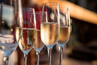 Four elegant glasses of champagne lined up, ready for a celebration at the Top Sail Lounge on MSC Meraviglia | MSC Cruises