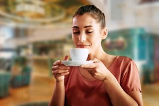 A woman enjoys a cappuccino at L'Espresso Coffee Bar on MSC Splendida | MSC Cruises