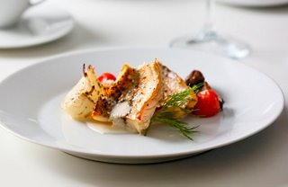 A beautifully presented dish featuring fish and vegetables, served at the Ocean Cay Restaurant | MSC Cruises