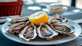 A beautifully arranged plate of fresh oysters with a lemon slice, served at the Ocean Cay Restaurant | MSC Cruises