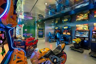 A vibrant family entertainment area filled with various virtual games aboard the MSC Poesia ship | MSC Cruises