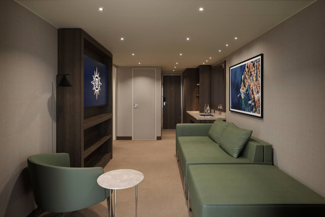 A spacious MSC Yacht Club Executive and Family Suite with a balcony featuring a sofa bed and modern furnishings | MSC Cruises