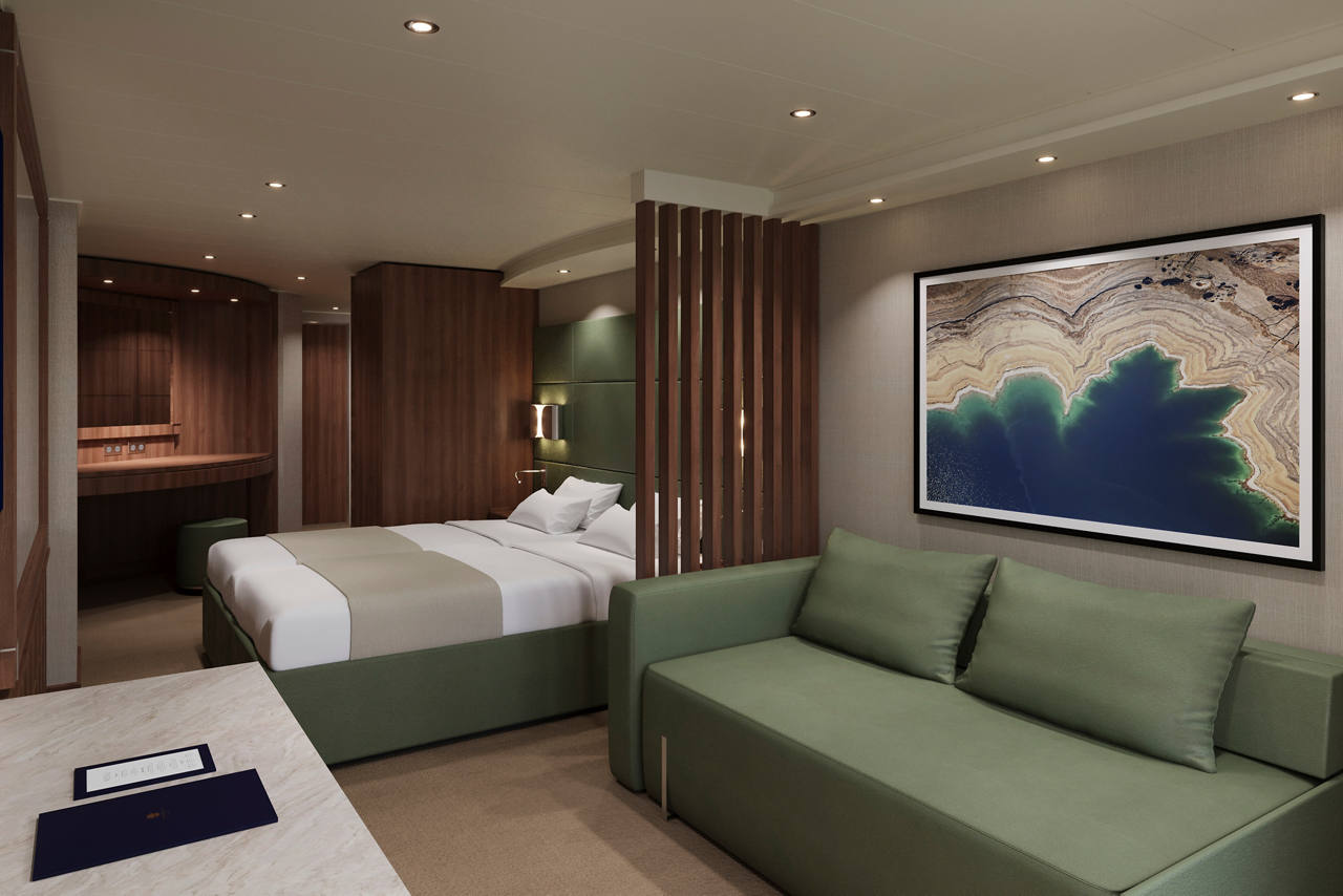 A spacious MSC Yacht Club Deluxe Suite featuring a double bed and a comfortable sofa bed | MSC Cruises