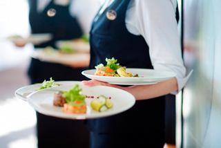 Waitstaff carry beautifully presented dishes in the restaurant of MSC World Europa | MSC Cruises