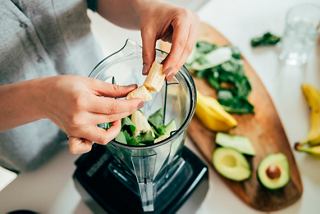 A person prepares fresh ingredients, including banana and avocado, for a healthy smoothie at MSC World Europa | MSC Cruises