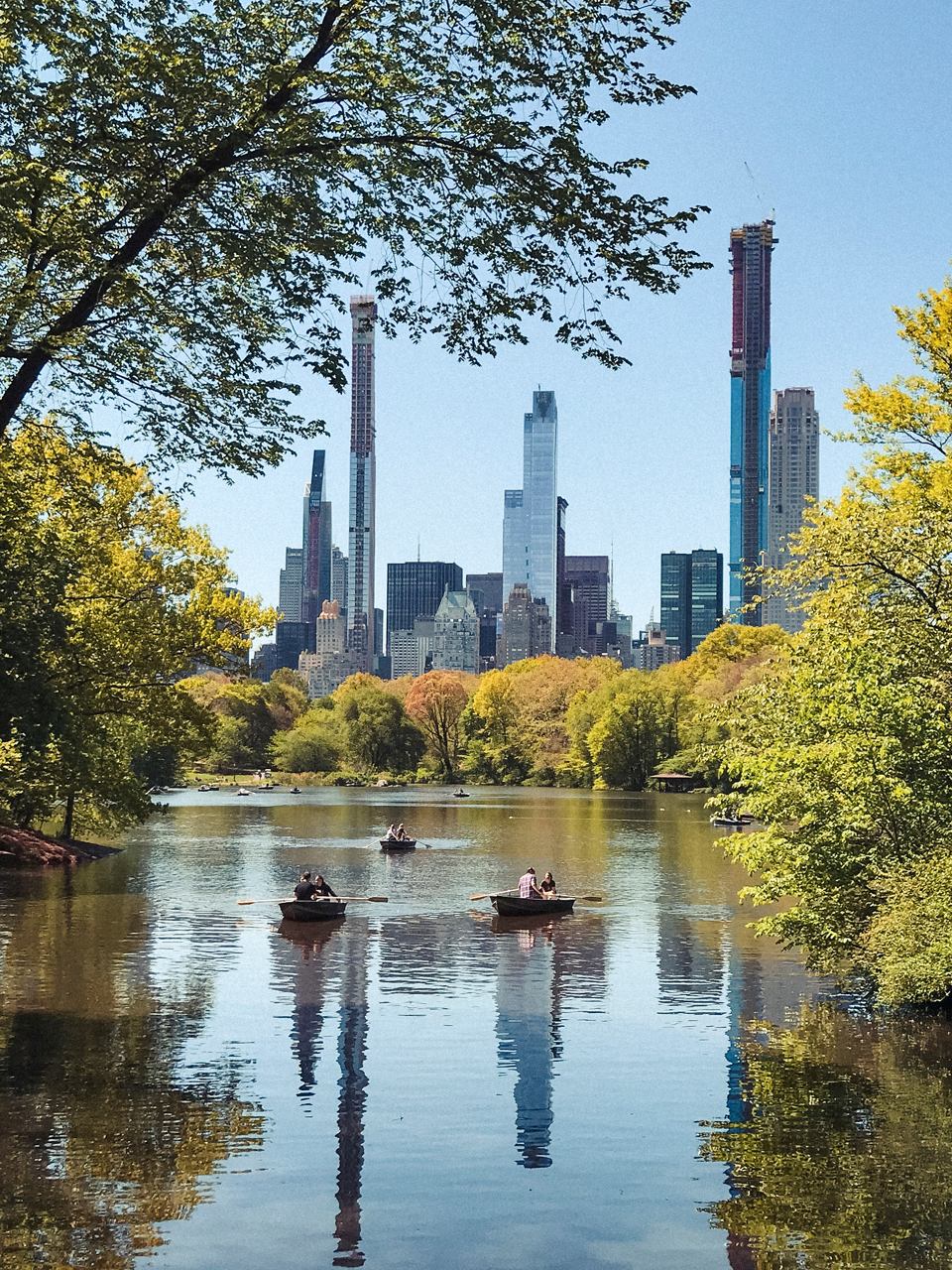 Central Park's tranquil waters reflect New York City's iconic skyscrapers amidst vibrant autumn foliage | MSC Cruises