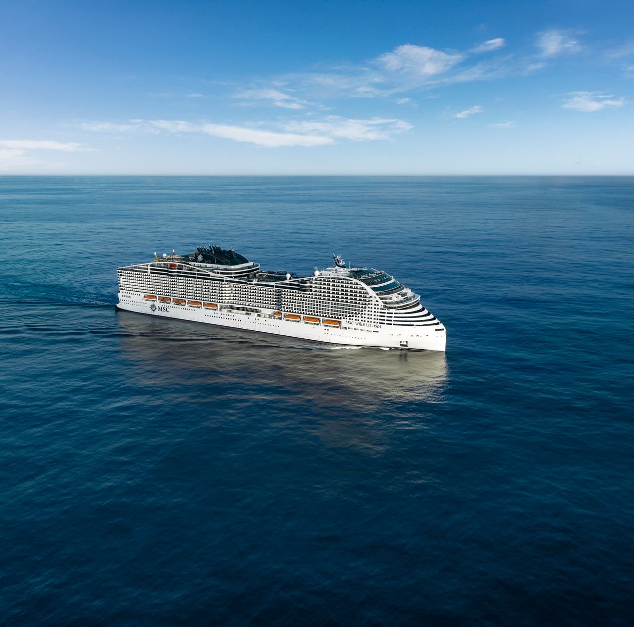 The MSC World Asia ship sails on calm seas beneath a blue sky | MSC Cruises