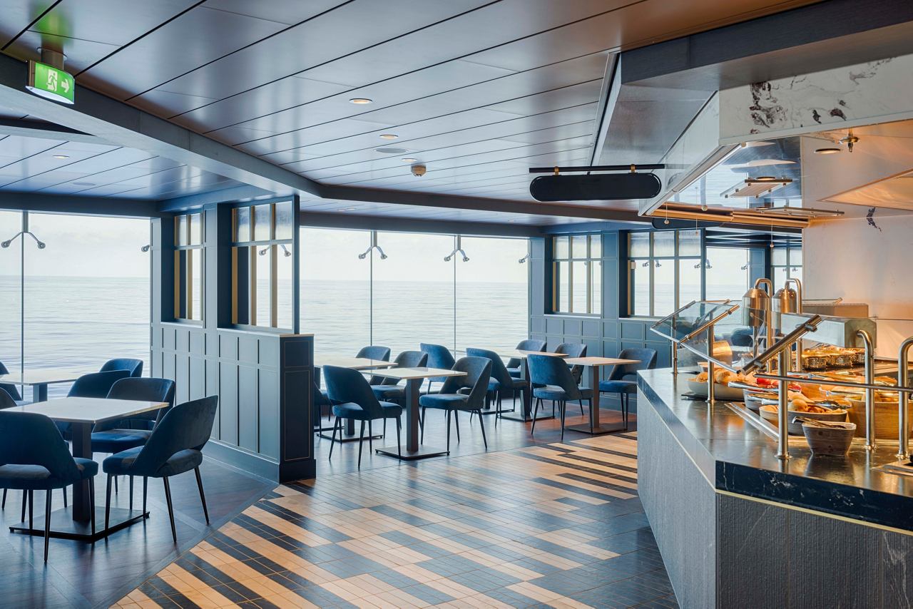 Modern dining area with comfortable seating and large windows offering sea views | MSC Cruises