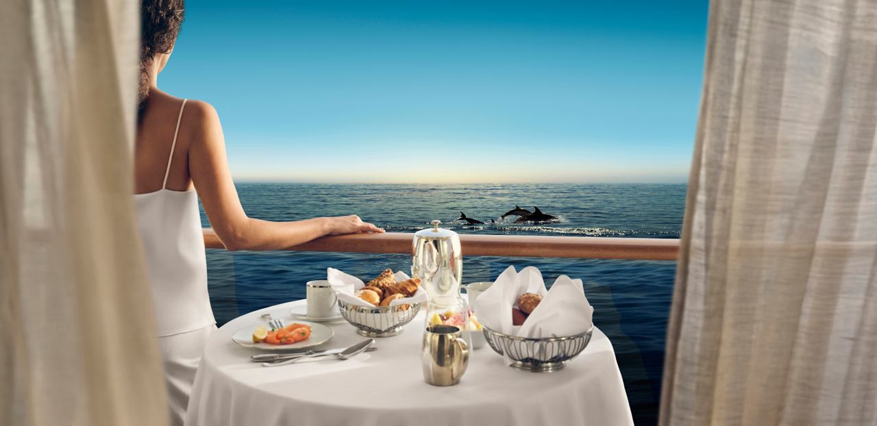 Woman enjoys breakfast on the balcony with a view of the sea | MSC Cruises