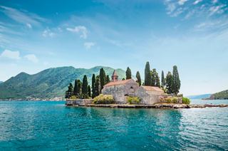St. George Island in Kotor, Montenegro, with stunning mountains and clear blue sea | MSC Cruises