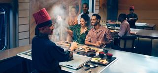 A couple enjoys a meal in a specialty restaurant aboard MSC World Europa | MSC Croisières