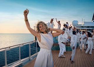 A woman dances on the ship's deck at sunset with friends | MSC Cruises